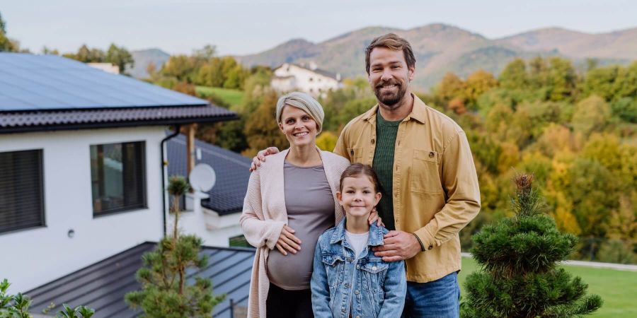 Family posing for camera outside of home Energy View