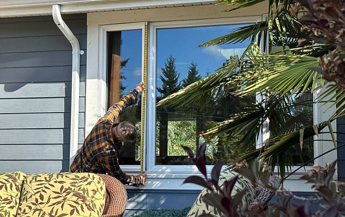 Rick using tape measure on home for client Energy View